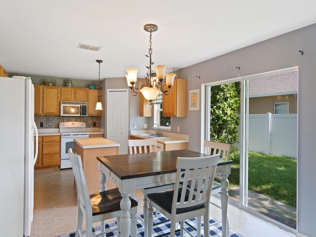 5985 Ridge Lake Circle Vero Beach, FL 32967 - Photo 6 of 27 a view of a dining room with furniture window and outside view