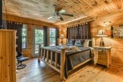 101 Moonshine Mountain Road Mineral Bluff, GA 30559 - Photo 17 of 70 a bed room with a bed and a table