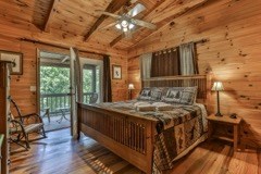101 Moonshine Mountain Road Mineral Bluff, GA 30559 - Photo 24 of 70 a bedroom with a bed and wooden floor