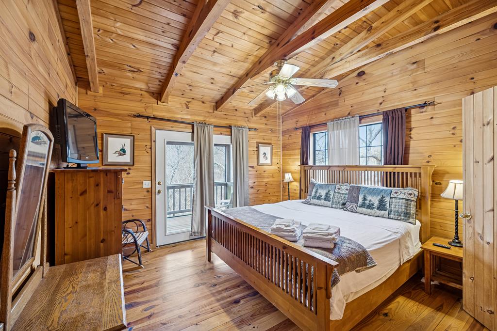 101 Moonshine Mountain Road Mineral Bluff, GA 30559 - Photo 29 of 70 a large bedroom with a bed and wooden floor