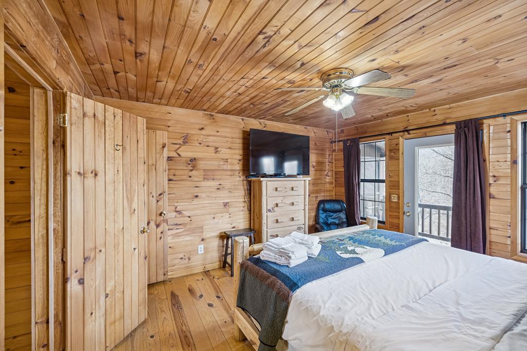 101 Moonshine Mountain Road Mineral Bluff, GA 30559 - Photo 37 of 70 a bedroom with a bed and a flat tv screen