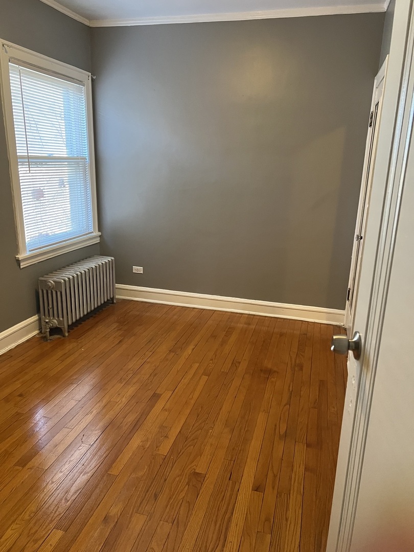 1243 West 96th Street Chicago, IL 60643 - Photo 4 of 13 a view of an empty room with wooden floor and a window