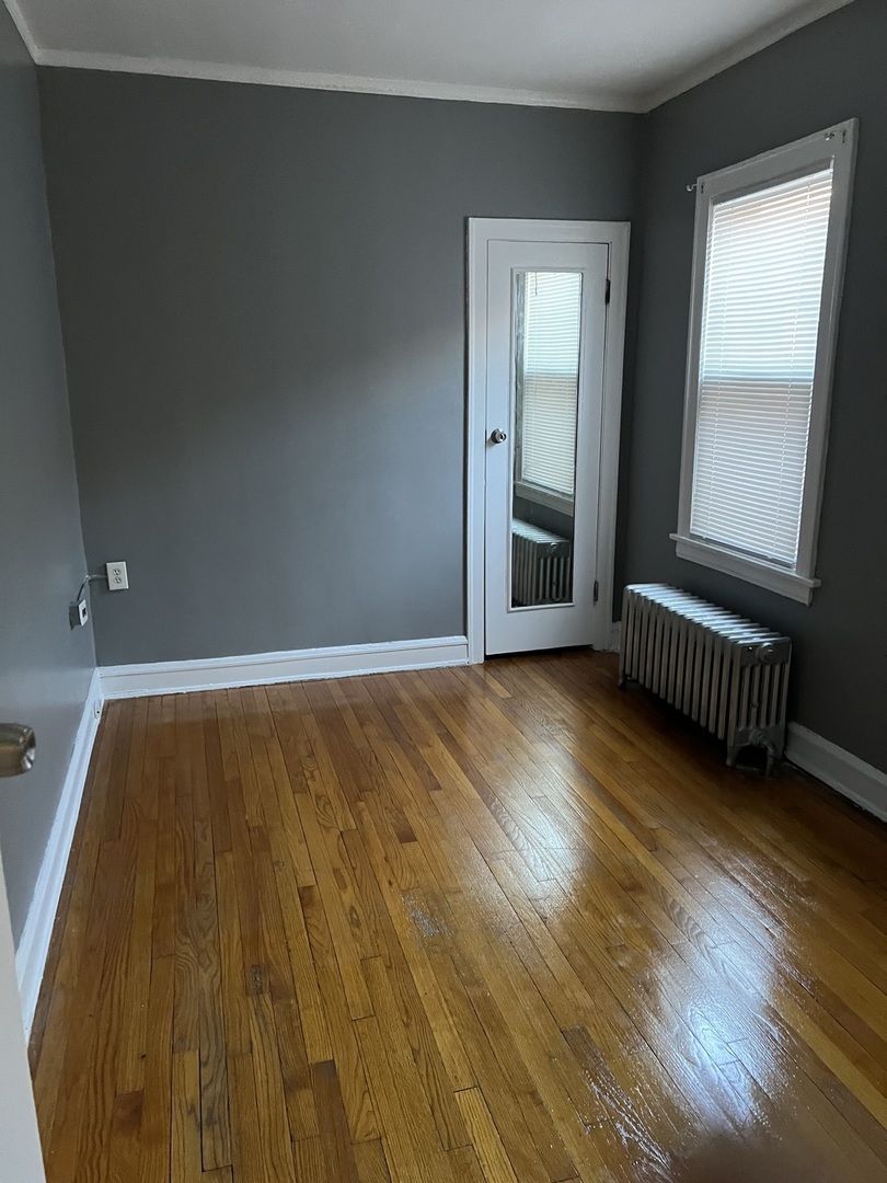 1243 West 96th Street Chicago, IL 60643 - Photo 5 of 13 an empty room with wooden floor and windows