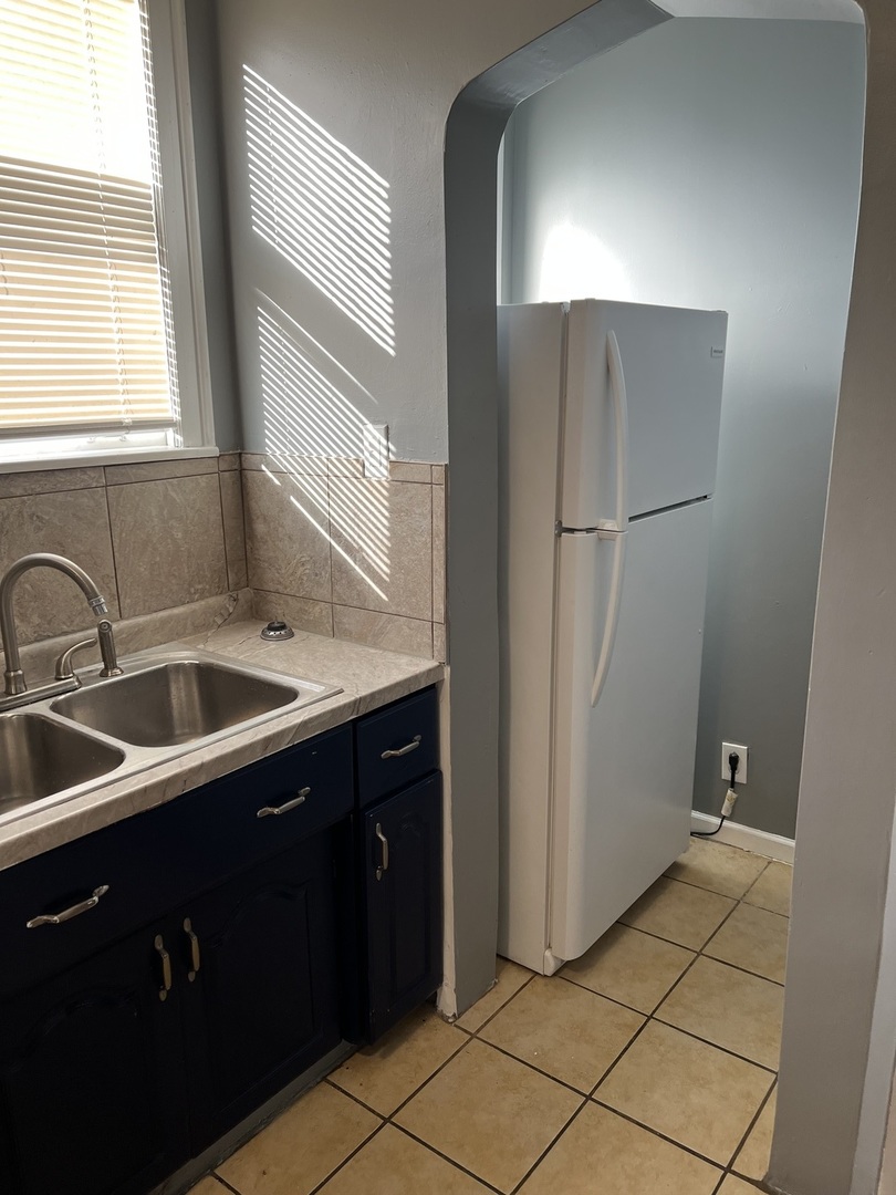 1243 West 96th Street Chicago, IL 60643 - Photo 10 of 13 a kitchen with a sink and a refrigerator