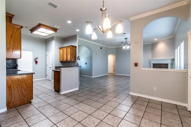 a view of a kitchen with kitchen island granite countertop cabinets and a counter top space
