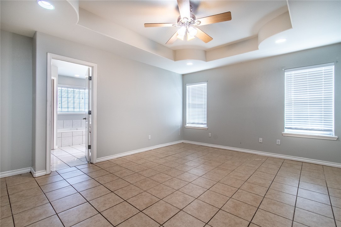 103 Collins Street Odem, TX 78370 - Photo 14 of 32 an empty room with fan and windows