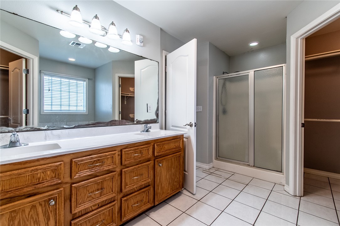 103 Collins Street Odem, TX 78370 - Photo 17 of 32 a spacious bathroom with a double vanity sink mirror and shower
