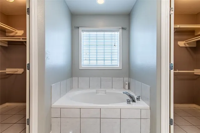 a white bath tub sitting next to a window