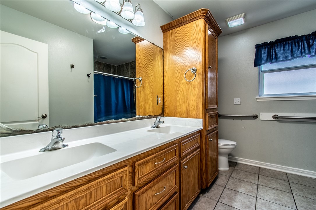 103 Collins Street Odem, TX 78370 - Photo 26 of 32 a bathroom with a sink double vanity and a mirror