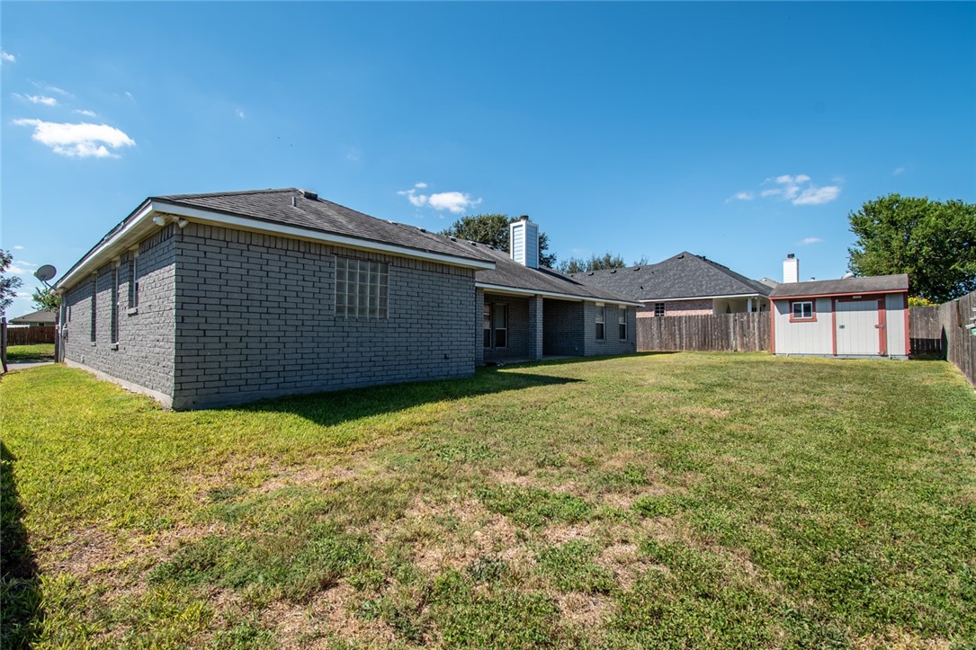 103 Collins Street Odem, TX 78370 - Photo 31 of 32 a front view of a house with a garden