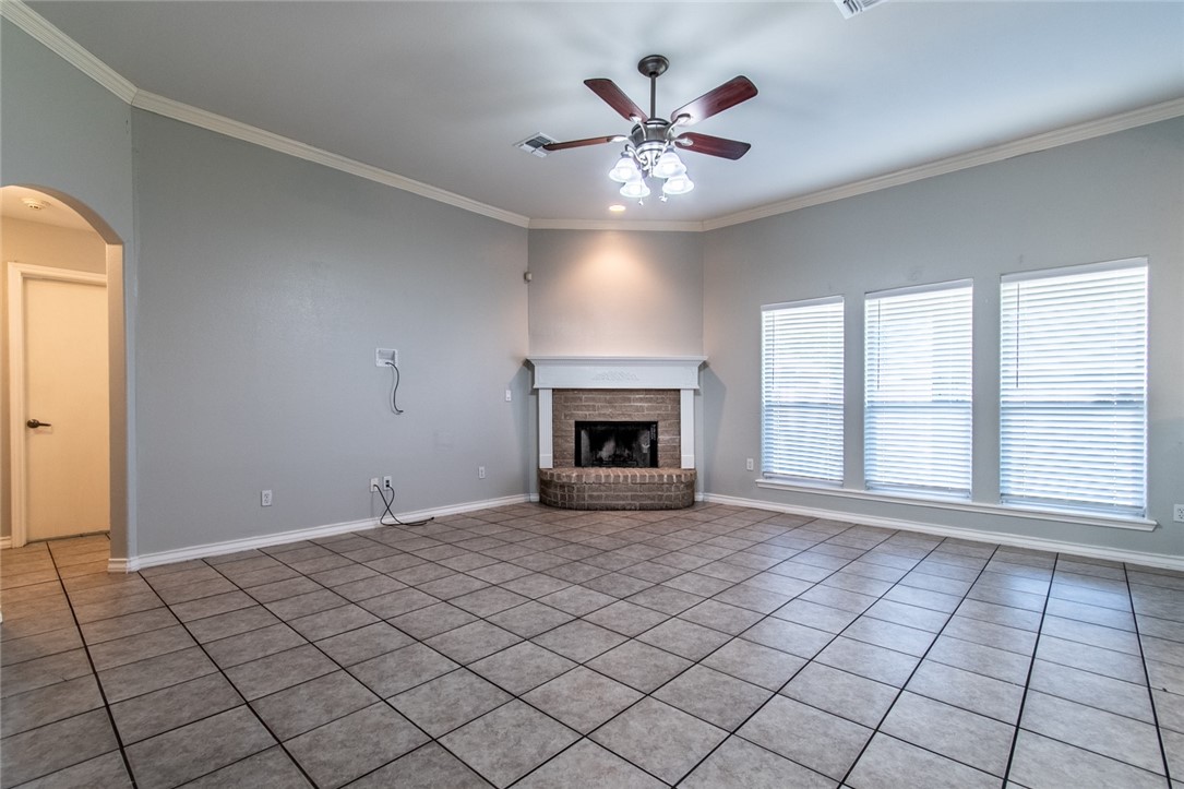 103 Collins Street Odem, TX 78370 - Photo 4 of 32 a view of an empty room with window and chandelier fan