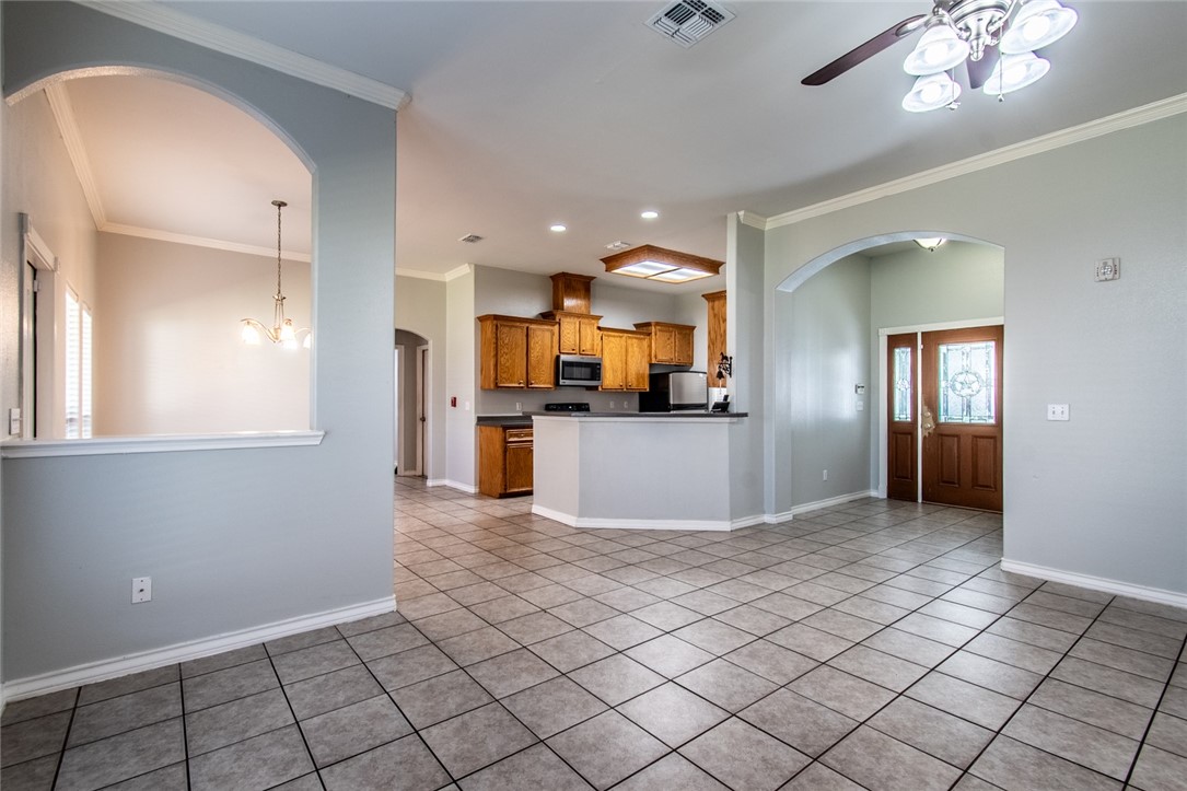103 Collins Street Odem, TX 78370 - Photo 6 of 32 a view of a kitchen with furniture and wooden floor