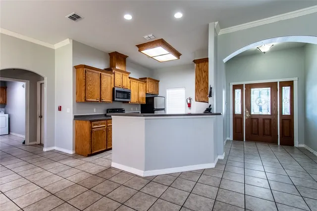 a view of a kitchen with fridge and a sink