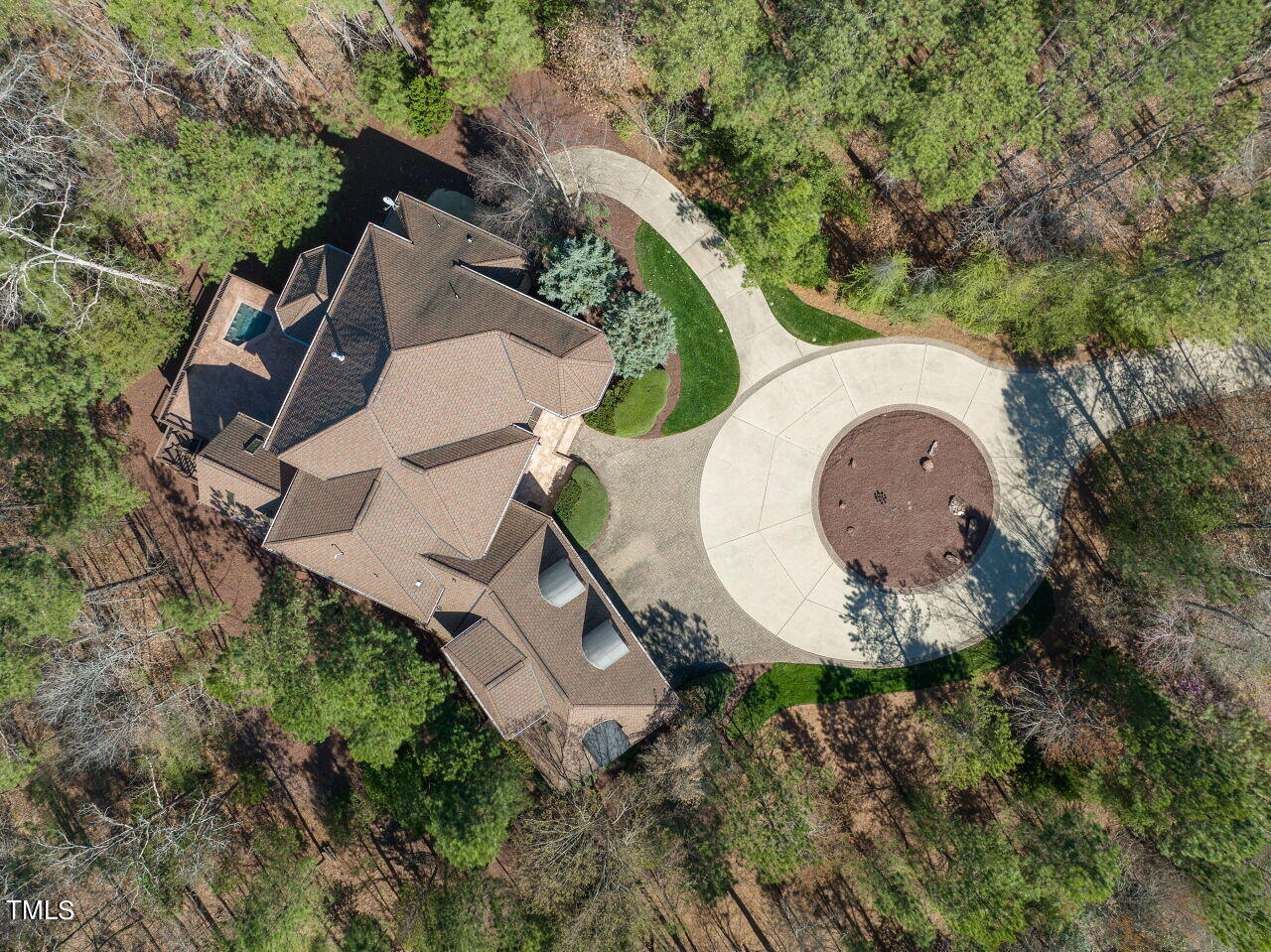 an aerial view of a house with a swimming pool and a yard