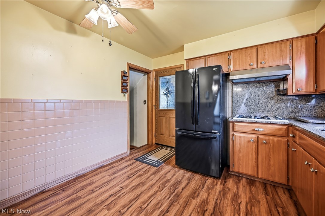 267 Butler Road Northeast Warren, OH 44483 - Photo 23 of 50 Kitchen with wood finish cabinetry, freestanding refrigerator, a wainscoted wall, dark wood finished floors, and ceiling fan