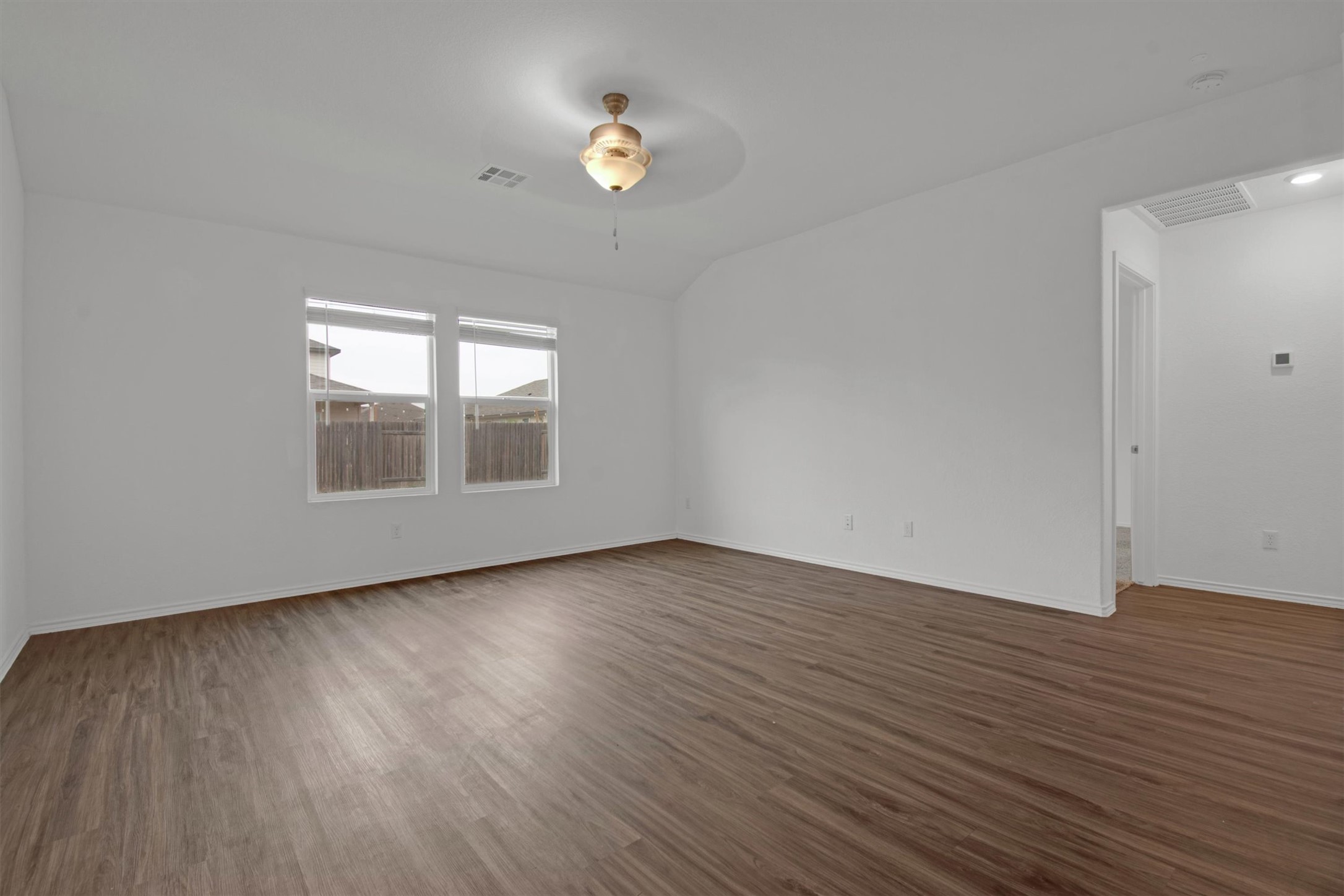 703 Bluejack Way Hutto, TX 78634 - Photo 13 of 19 Unfurnished room with dark wood-style floors and a ceiling fan
