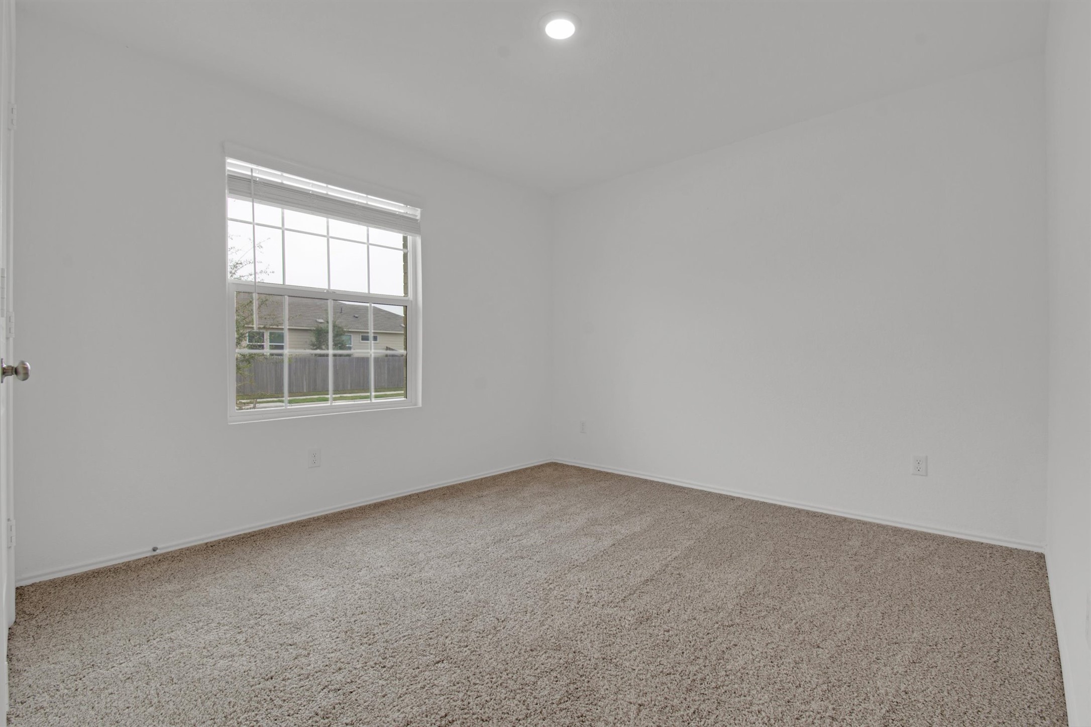 703 Bluejack Way Hutto, TX 78634 - Photo 15 of 19 Unfurnished room with light carpet and recessed lighting