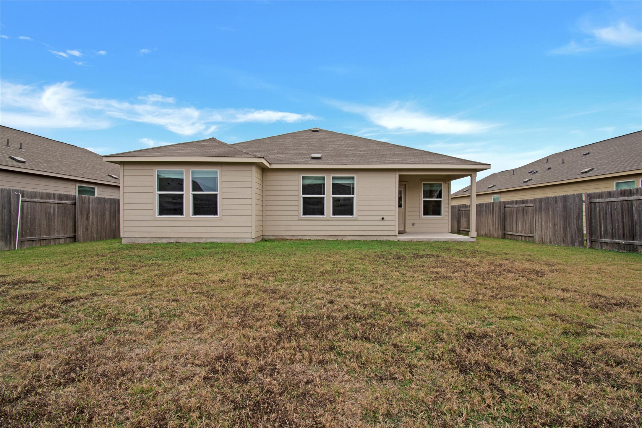 703 Bluejack Way Hutto, TX 78634 - Photo 18 of 19 Back of property with a patio area and a fenced backyard