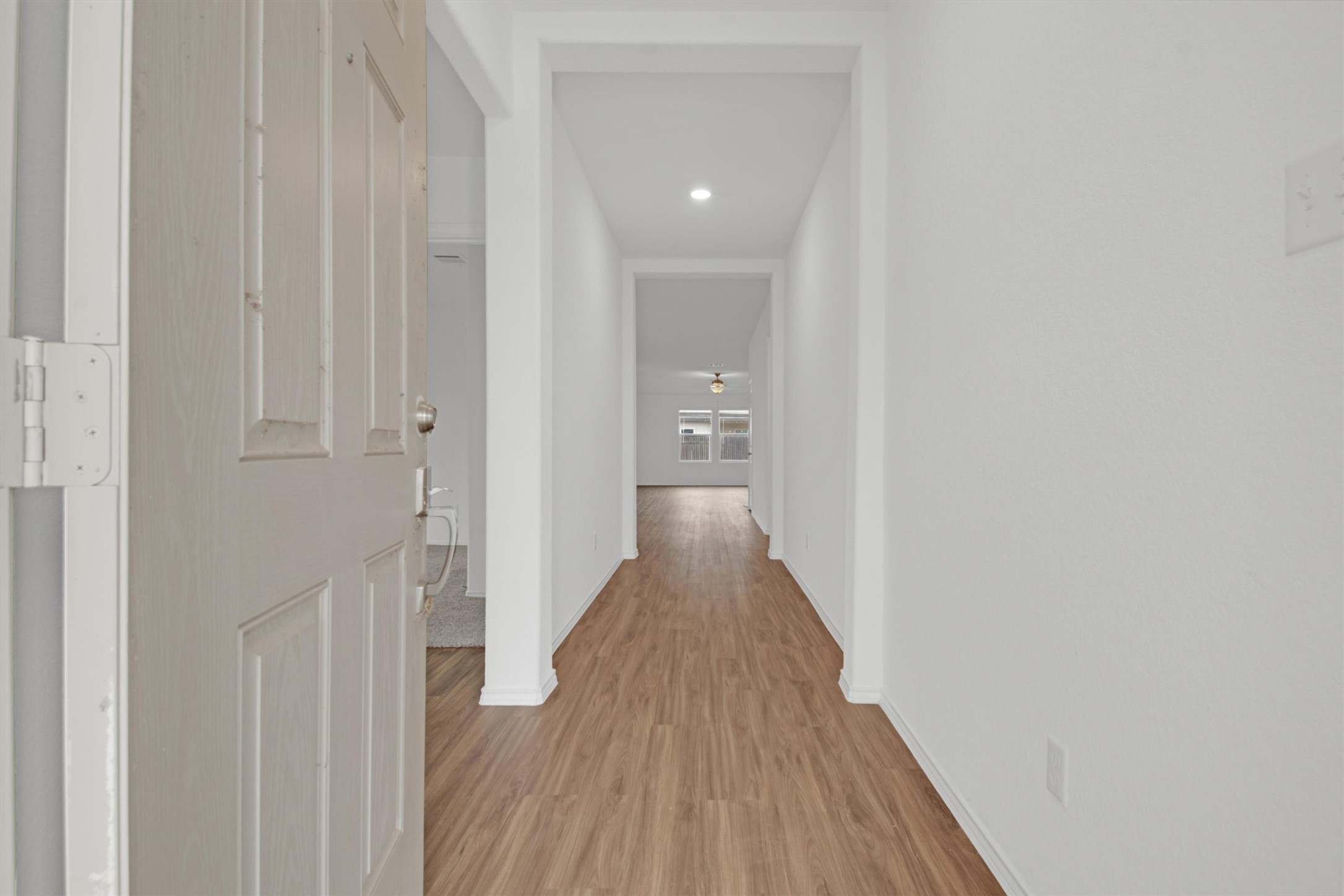 703 Bluejack Way Hutto, TX 78634 - Photo 3 of 19 Hall with light wood-style floors and recessed lighting
