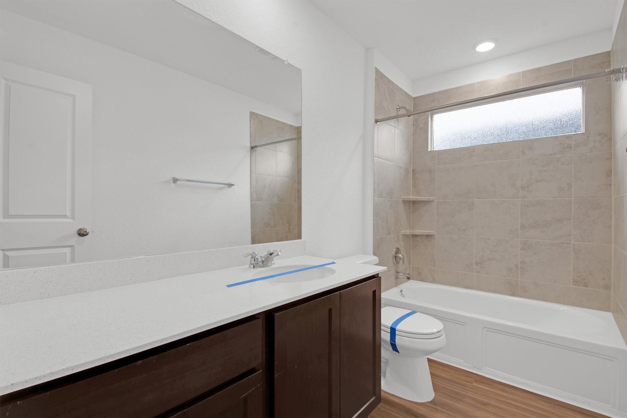 703 Bluejack Way Hutto, TX 78634 - Photo 4 of 19 Full bathroom with shower combination, vanity, and light wood-style flooring