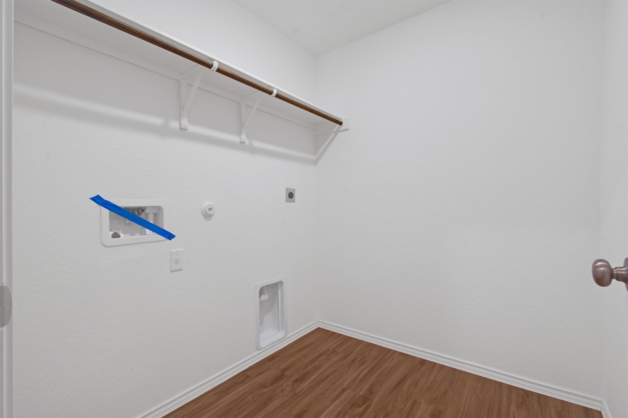 703 Bluejack Way Hutto, TX 78634 - Photo 6 of 19 Washroom featuring hookup for a gas dryer, dark wood-type flooring, electric dryer hookup, and washer hookup
