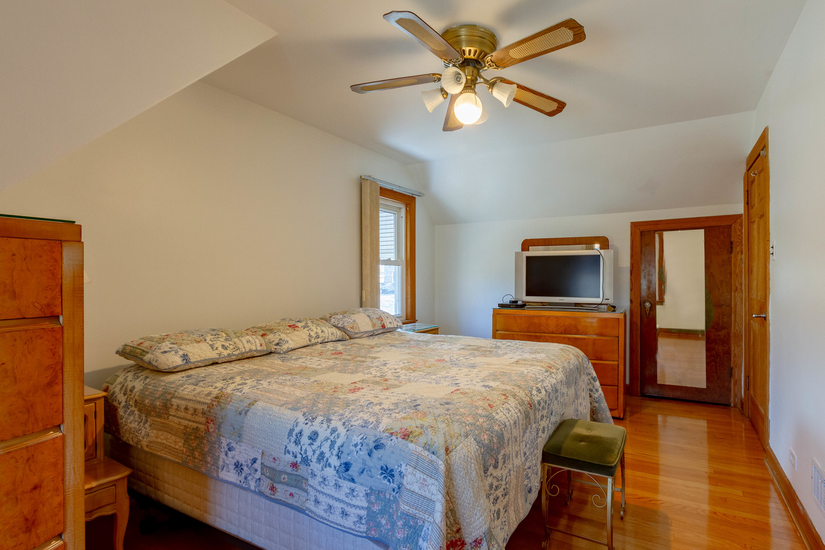 6410 Sinclair Avenue Berwyn, IL 60402 - Photo 19 of 31 a bedroom with a bed and a chandelier