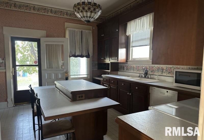 204 North Maple Street Christopher, IL 62822 - Photo 11 of 29 a kitchen with a table chairs sink and window