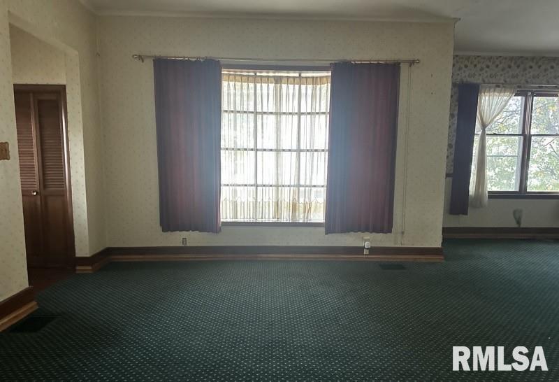 204 North Maple Street Christopher, IL 62822 - Photo 14 of 29 an empty room with wooden floor and windows