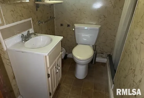 a bathroom with a sink and toilet
