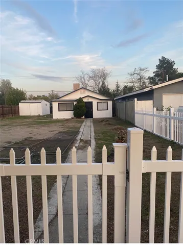 a view of a house with wooden fence