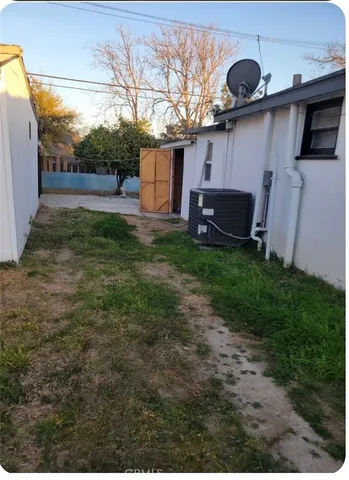 a backyard of a house with table and chairs