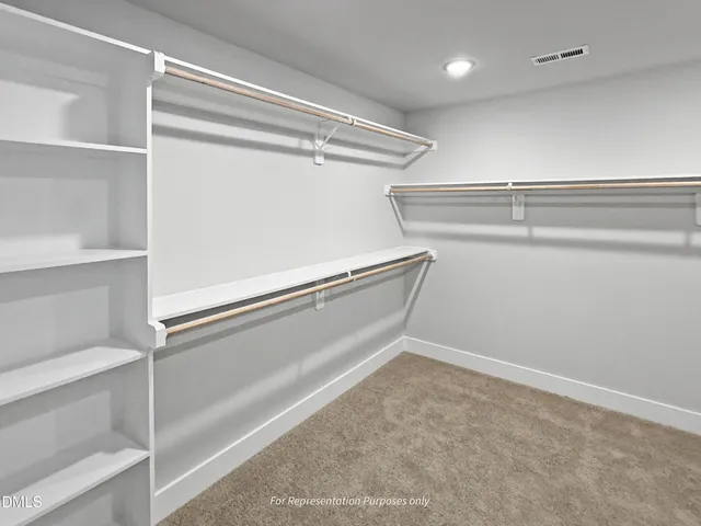 a bathroom with double vanity sink a mirror and a toilet