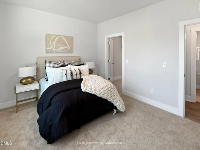 a bedroom with a bed and painting on the wall