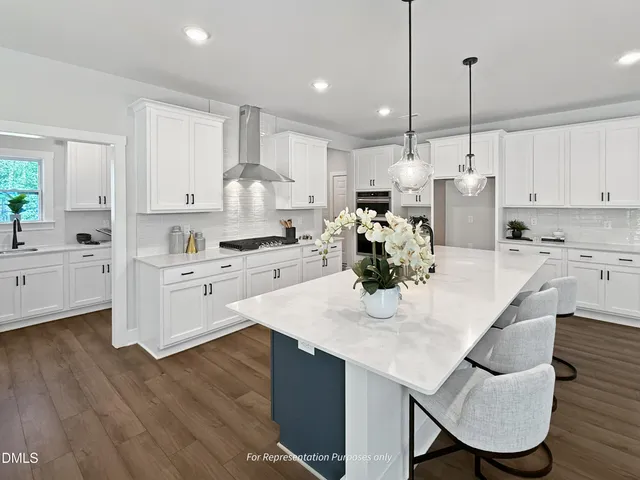 a kitchen with white cabinets and appliances