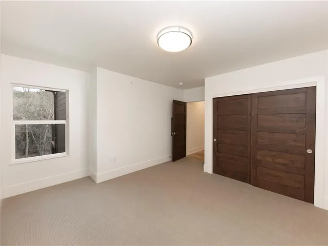 a view of an empty room with closet