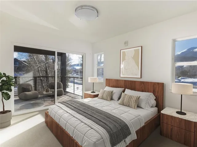 a bedroom with a bed and a lamp