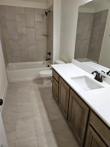 a bathroom with a tub sink a mirror and shower