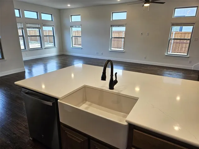 a kitchen with a sink and chandelier