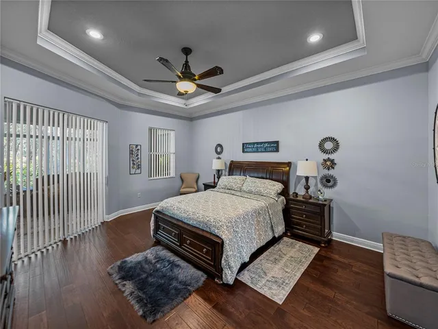 a bedroom with bed and wooden floor