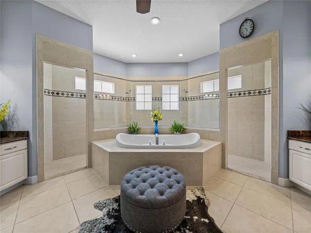 a living room with stainless steel appliances furniture a rug and a window