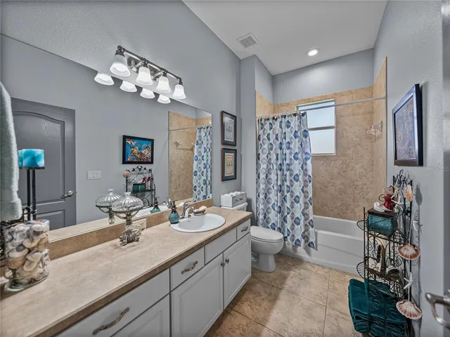 a bathroom with double vanity sinks a mirror a vanity and a shower