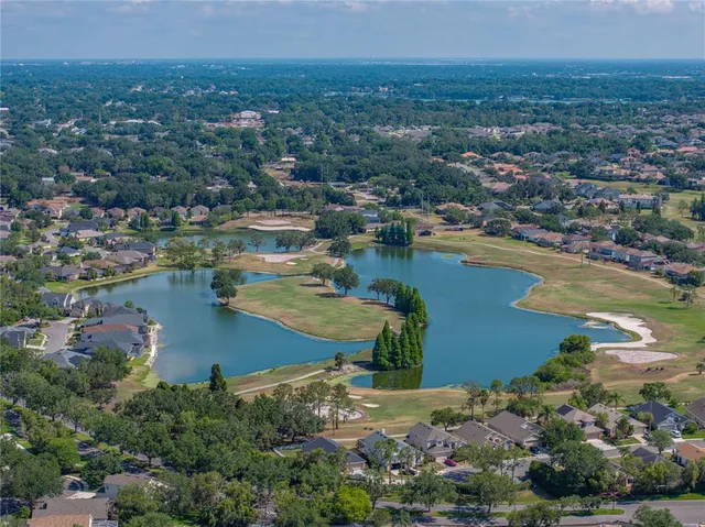 an aerial view of residential houses with outdoor space and lake view