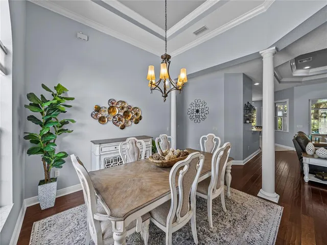 a view of a dining room with furniture and chandelier