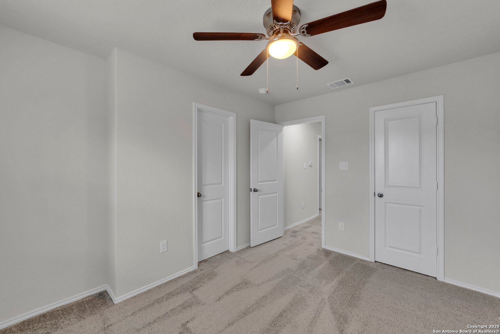 8711 Key Windy Way, Unit 2 Converse, TX 78109 - Photo 13 of 22 an empty room with chandelier fan