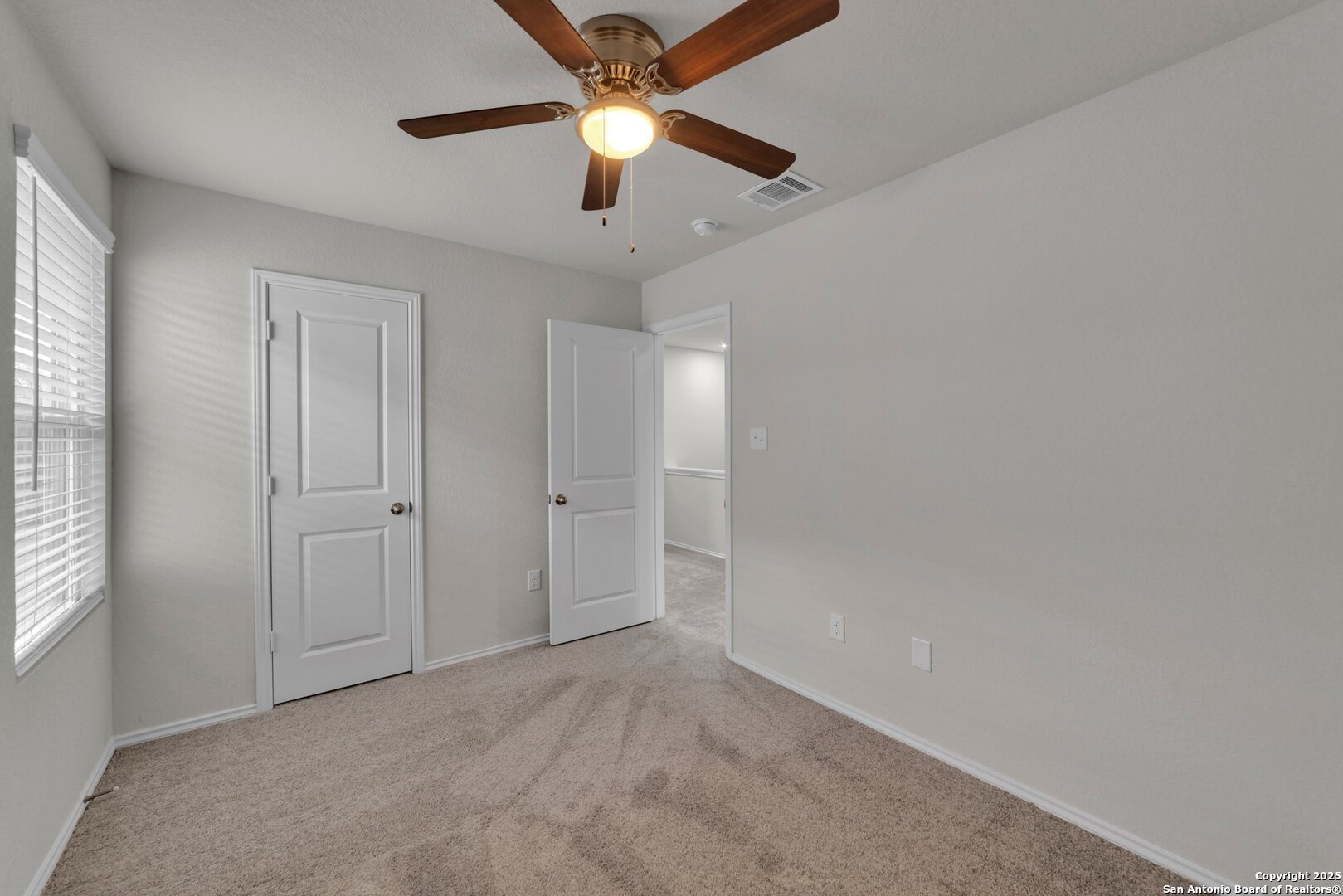 8711 Key Windy Way, Unit 2 Converse, TX 78109 - Photo 15 of 22 an empty room with chandelier fan