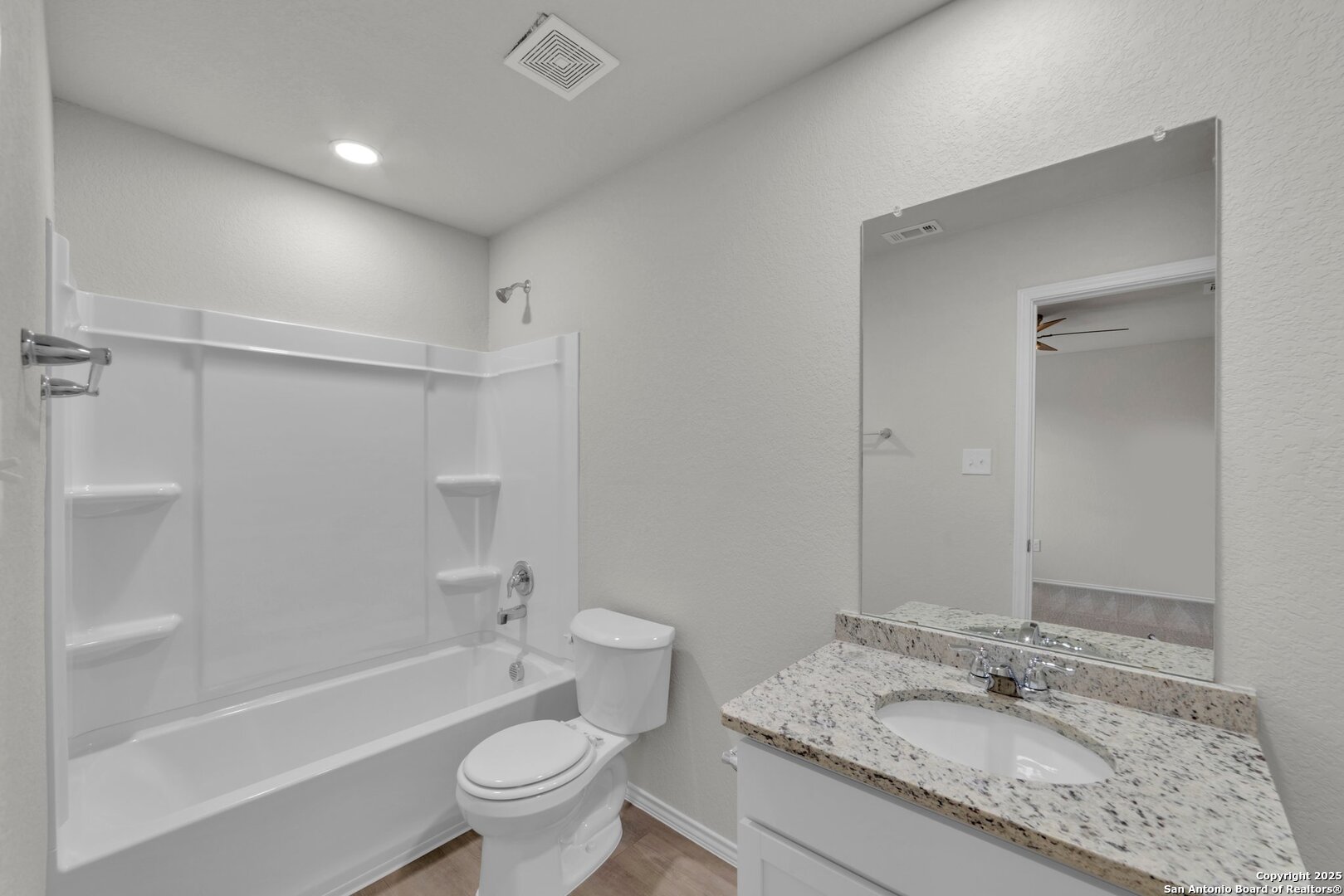 8711 Key Windy Way, Unit 2 Converse, TX 78109 - Photo 20 of 22 a bathroom with a granite countertop sink toilet and shower