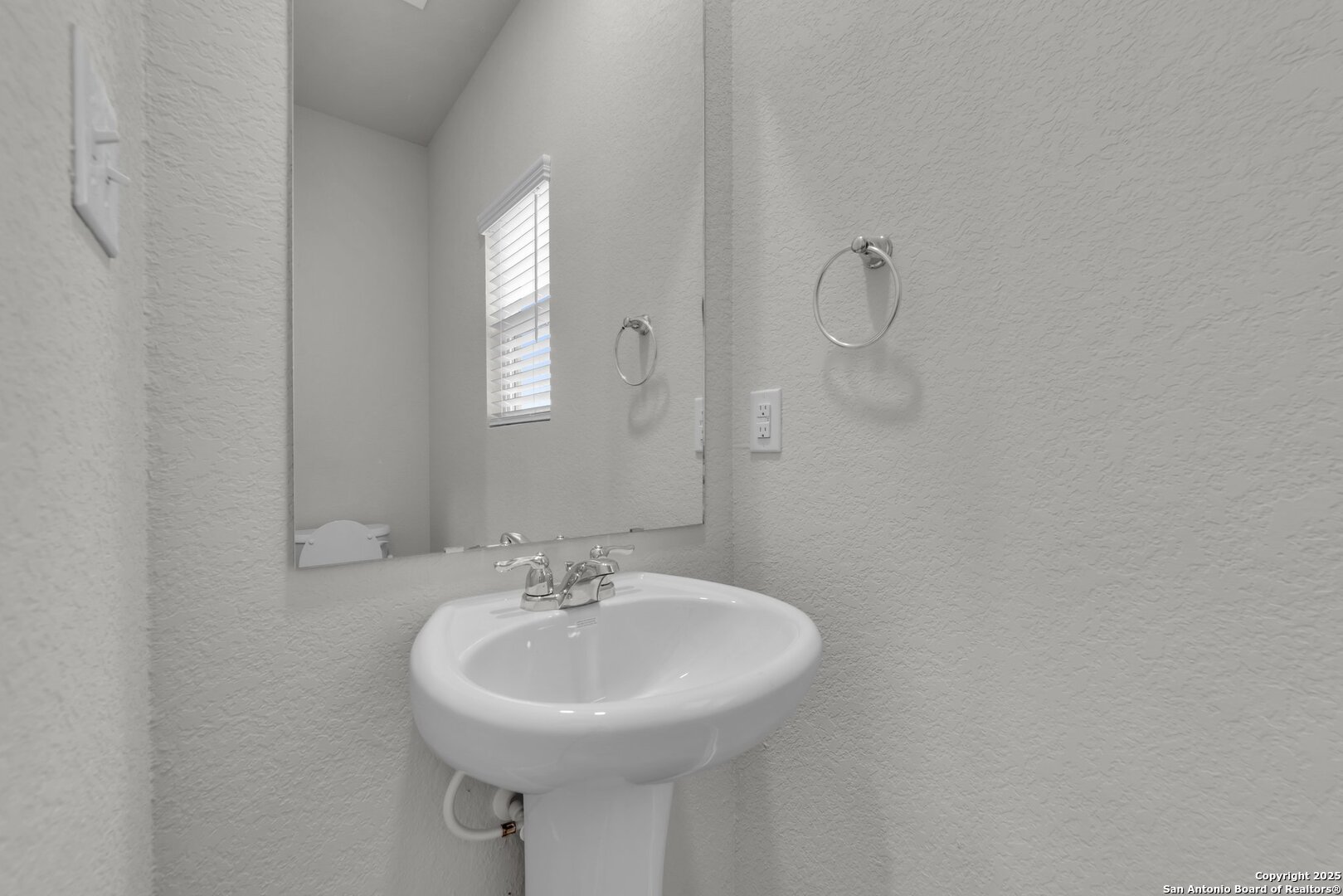 8711 Key Windy Way, Unit 2 Converse, TX 78109 - Photo 5 of 22 a bathroom with a sink and mirror