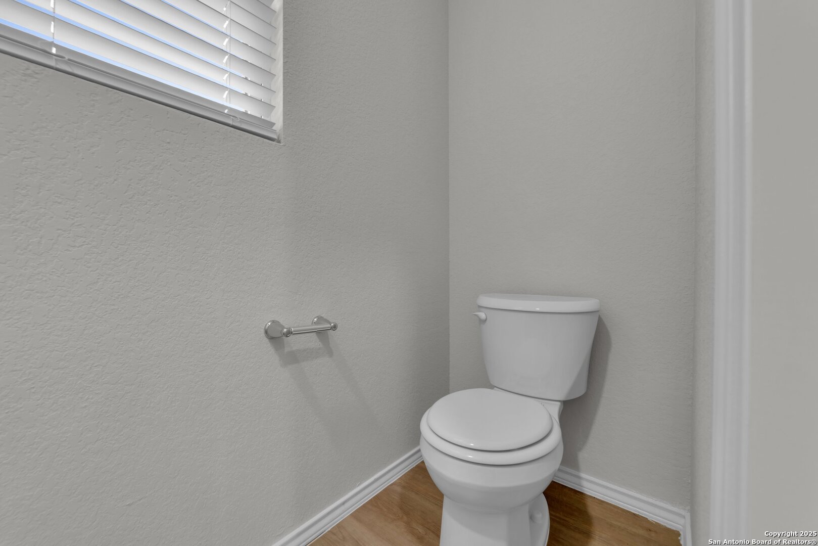 8711 Key Windy Way, Unit 2 Converse, TX 78109 - Photo 6 of 22 a white toilet sitting next to a white wall