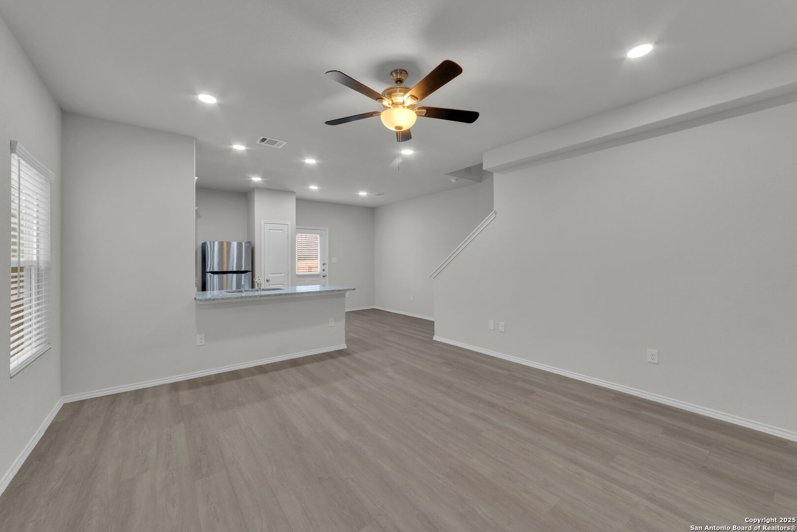 8711 Key Windy Way, Unit 2 Converse, TX 78109 - Photo 8 of 22 an empty room with wooden floor and windows