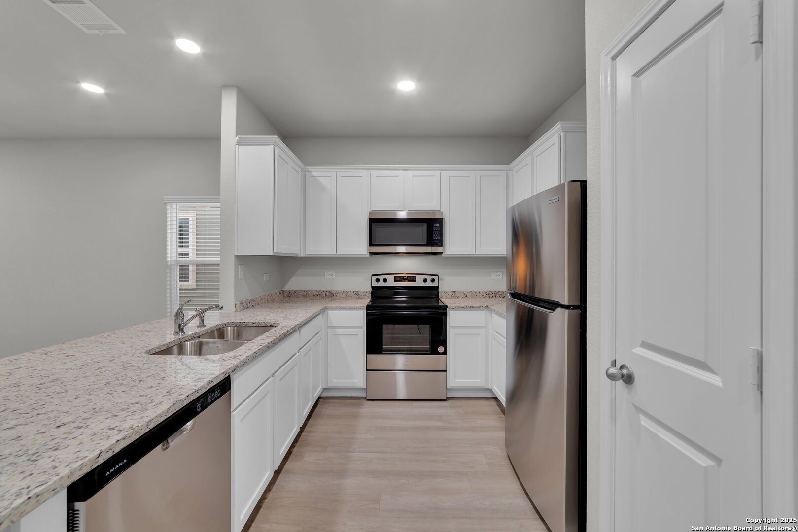 8711 Key Windy Way, Unit 2 Converse, TX 78109 - Photo 10 of 22 a kitchen with a sink and stainless steel appliances